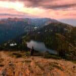 Hiker walking at the top of Mount Aeneas during sunrise, overlooking the Jewel basin