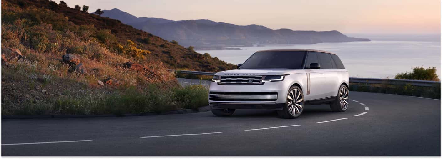 White 2025 Range Rover Driving On Road