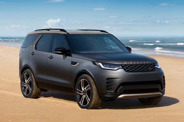 Discovery in dark gray front three-quarter view on sandy beach