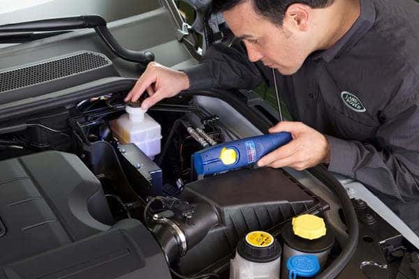 mechanic checking engine electronics