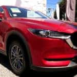 Red Mazda CX-5 being sold on a car dealer lot.