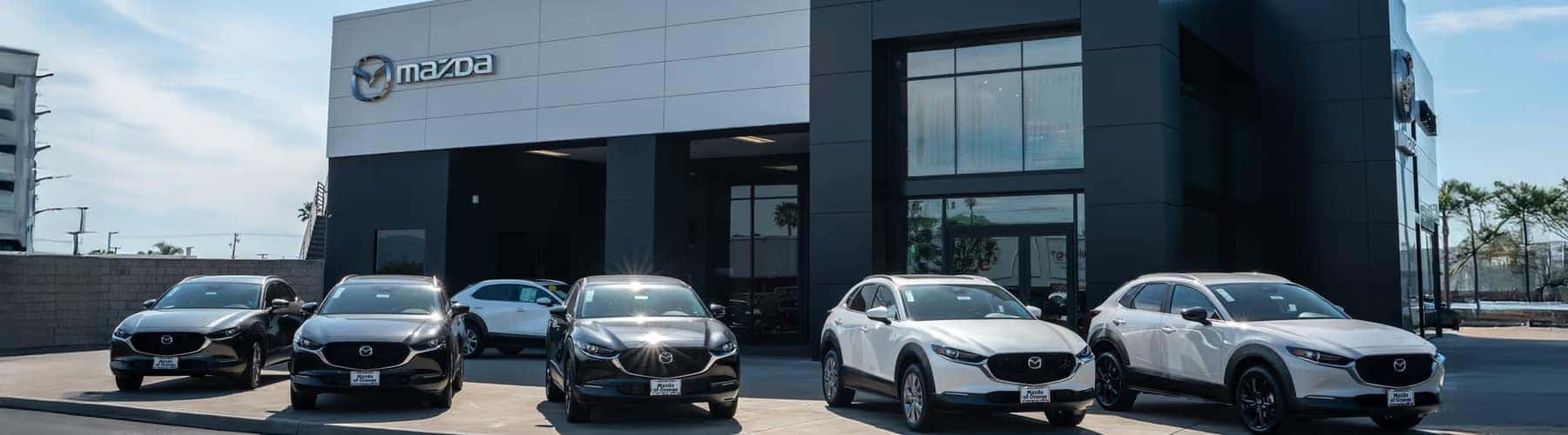 Used Mazda CX-5 SUVs parked at a dealership