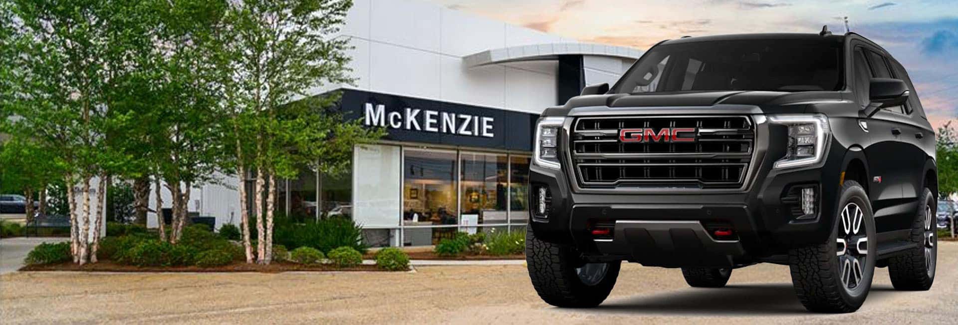 group of 2022 GMC Yukon and Yukon XL vehicles parked in the mountains
