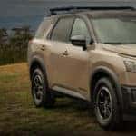 2023 Nissan Pathfinder driving in the grass