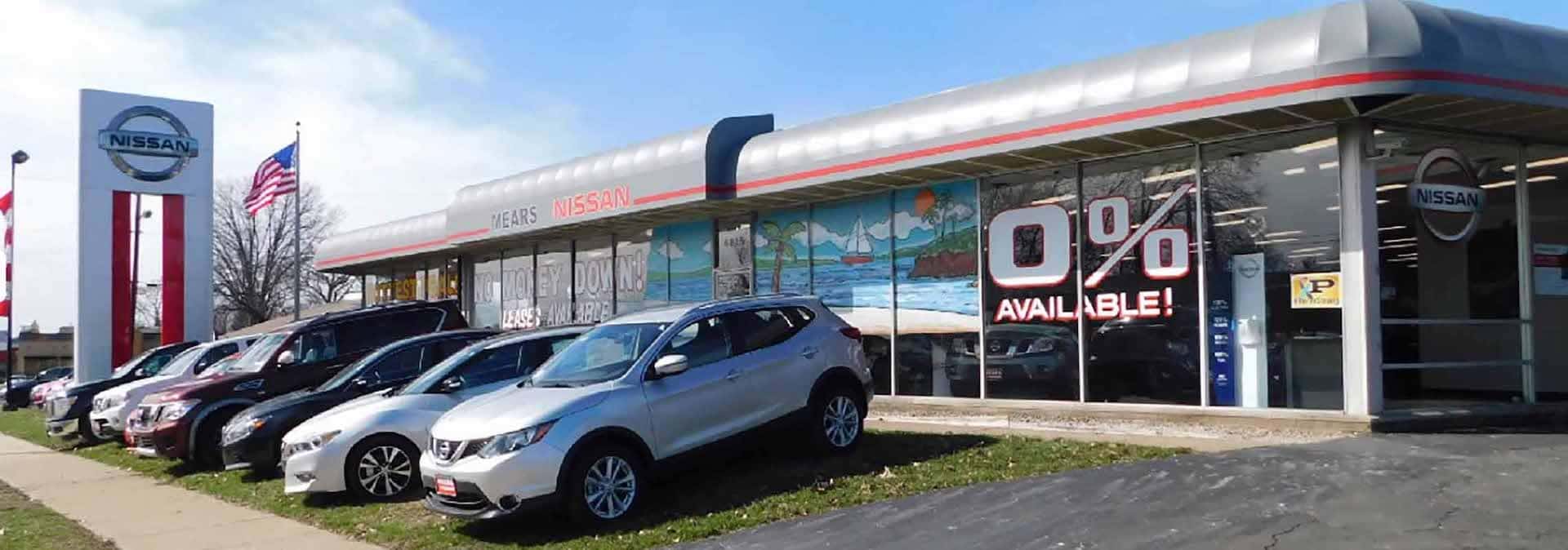 An exterior shot of Mears Nissan with vehicles parked out front