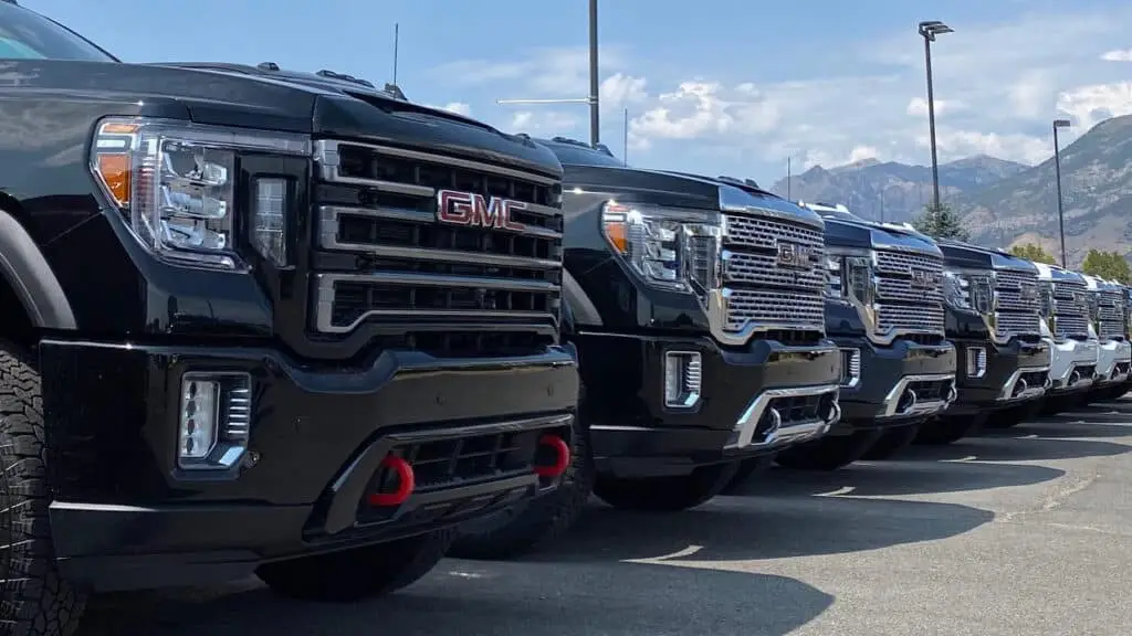 GMC Trucks nicely aligned against a mountain scenery