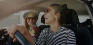 Lady driving a car with her friend