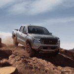 2023 Nissan Frontier driving on the rocks