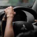 Person driving a Mitsubishi car.