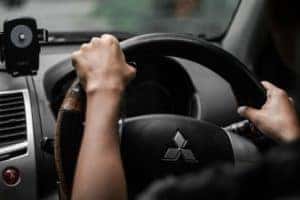 Person driving a Mitsubishi car.