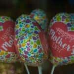 Close up picture of small balloons that say Happy Mothers Day