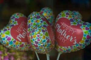 Close up picture of small balloons that say Happy Mothers Day