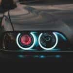 One side of headlights on a Mitsubishi car that are turned on