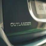 A zoomed in back view of a Mitsubishi Outlander with the license plate in the background