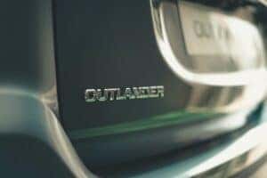 A zoomed in back view of a Mitsubishi Outlander with the license plate in the background