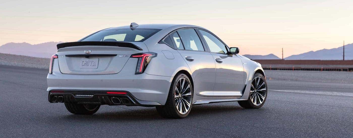 Rear view of a white 2022 Cadillac CT5-V Blackwing parked with mountains in the distance