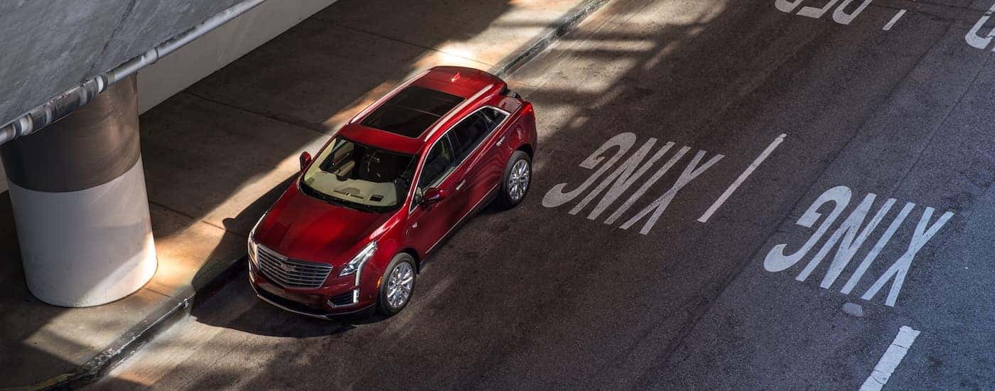 High angled view of a red 2017 Cadillac XT5 parked after leaving a used Cadillac dealership
