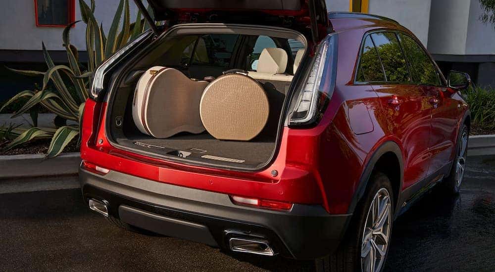Guitar case and luggae in the trunk of a red 2022 Cadillac XT4