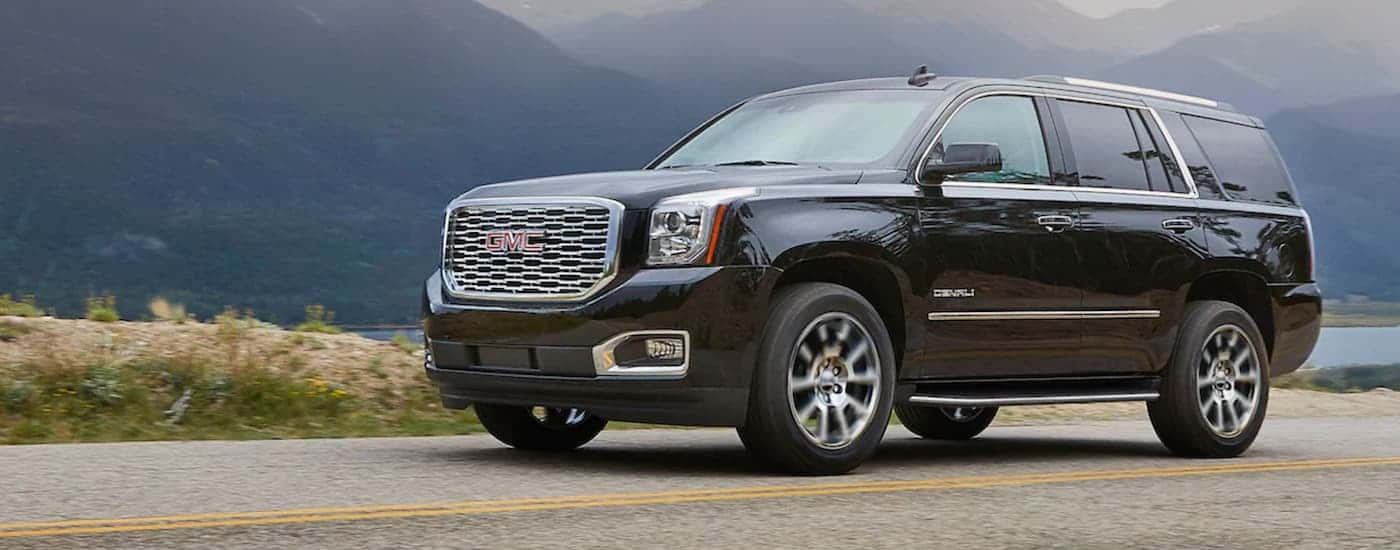 A black 2020 GMC Yukon is shown parked on an open lot.