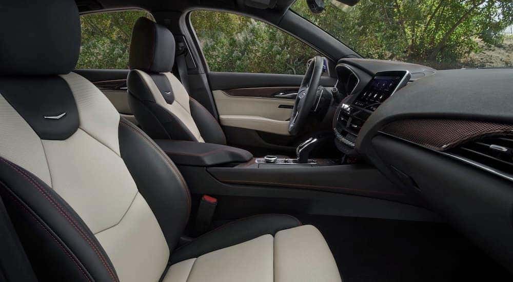 The white interior of a 2023 Cadillac CT5-V is shown from the passenger seat.