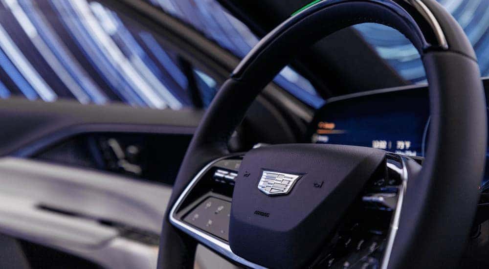 A close up of the steering wheel in a 2023 Cadillac Lyriq is shown.