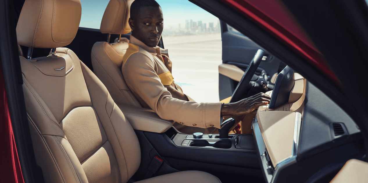 Side view of a driver inside the 2024 Cadillac XT4 luxury SUV