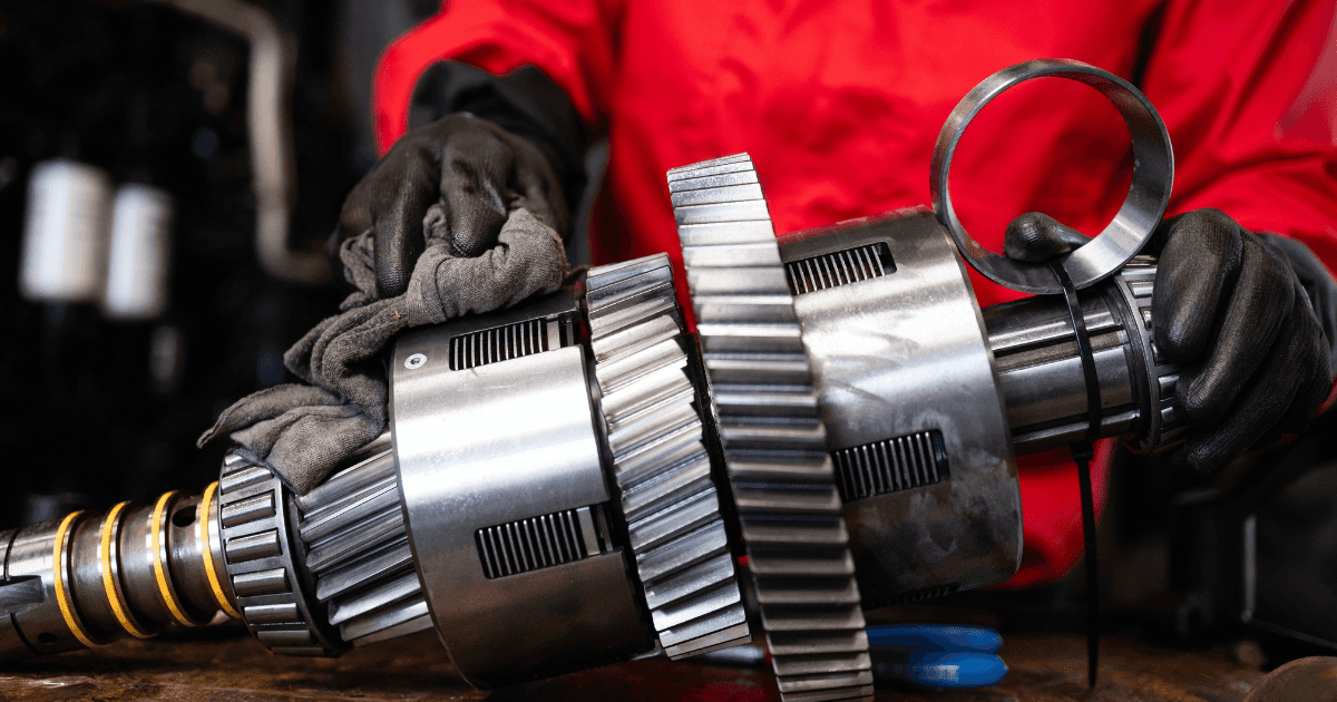 A technician repairing a vehicle's transmission