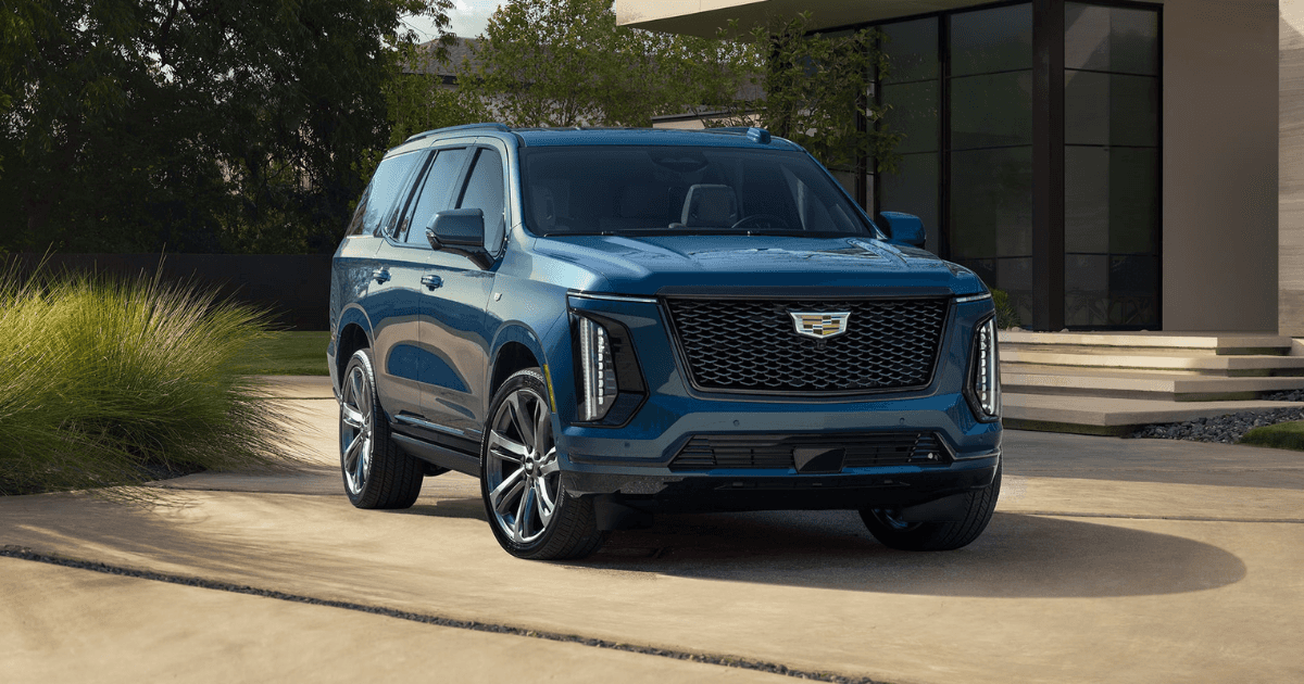 A blue 2025 Cadillac Escalade parked in front of a house