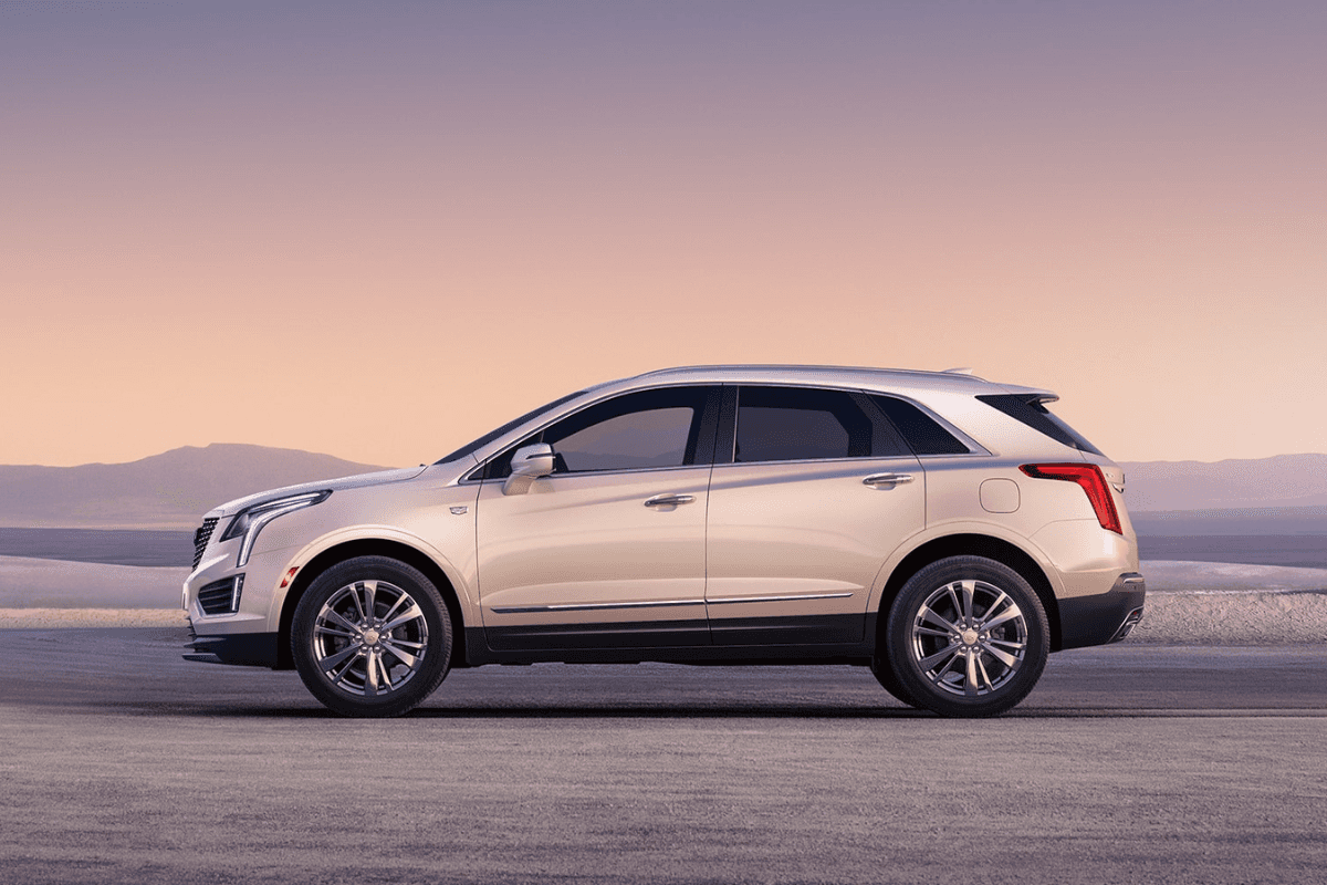 A grey Cadillac XT5 in a flat, desert-like area