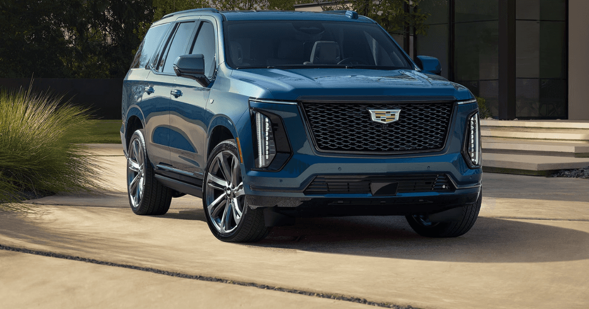 A blue 2026 Cadillac Escalade parked in front of a nice house