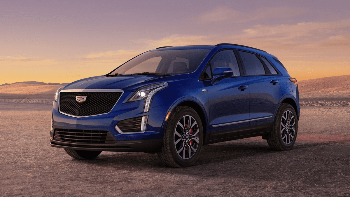 A blue Cadillac XT5 parked in a flat desert