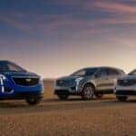 A blue, silver, and gray Cadillac XT5 on display in an open area