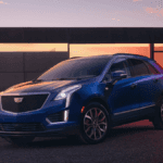 A blue Cadillac XT5 on display in the evening