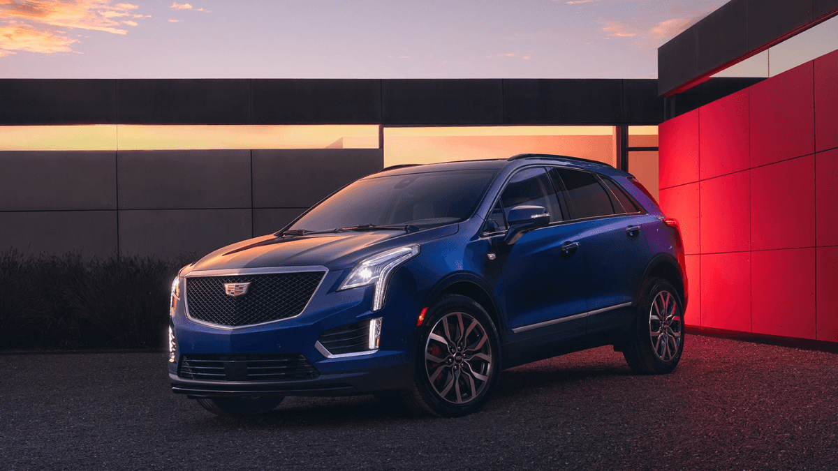 A blue Cadillac XT5 on display in the evening