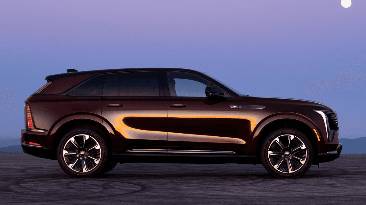 A maroon Cadillac IQ in profile in a desert at night