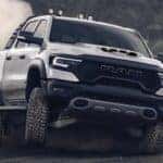 Dynamic front shot of a Ram TRX truck roaring on an off-road trail