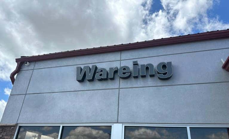 Wareing Belle Fourche signage on dealer facade