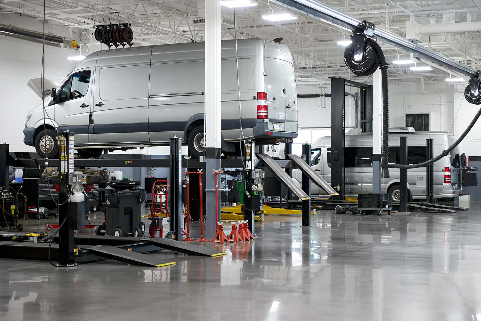 Mercedes-Benz Sprinter vans on service lifts at Mercedes-Benz Vans of Laguna Niguel