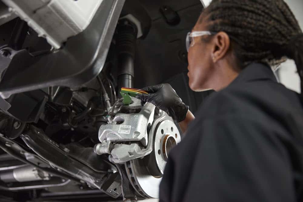 Technician servicing Sprinter brake calipers at Mercedes-Benz Vans of Laguna Niguel