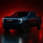A dark GMC pickup truck is spotlighted against a vivid red background, with its LED lighting and bold grille emphasizing a modern, aggressive look. The dramatic studio setting draws attention to the vehicle’s muscular stance and refined styling.