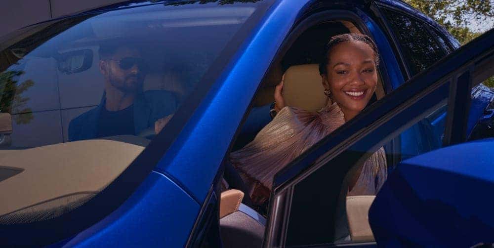 Couple exiting Cadillac vehicle