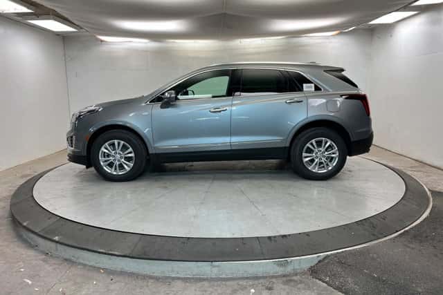 2026 Cadillac XT5 luxury SUV displayed on indoor turntable at Stephen Wade Cadillac dealership in St. George, UT