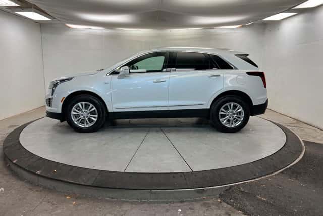 White 2026 Cadillac XT5 luxury SUV displayed indoors with a side profile view, highlighting comfort in St. George, UT