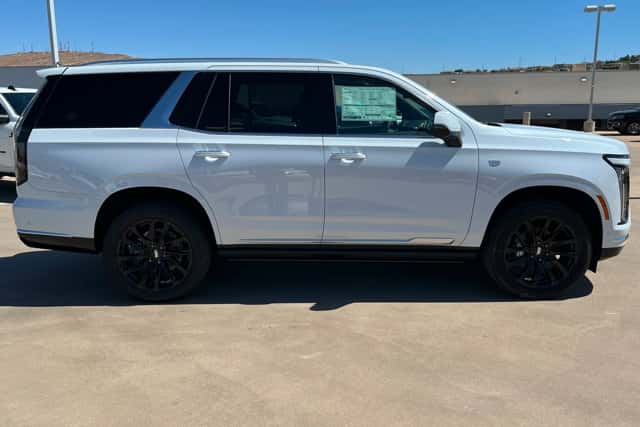 White Cadillac Escalade SUV shown in a side profile view at a dealership lot, highlighting luxury and space in St. George, UT