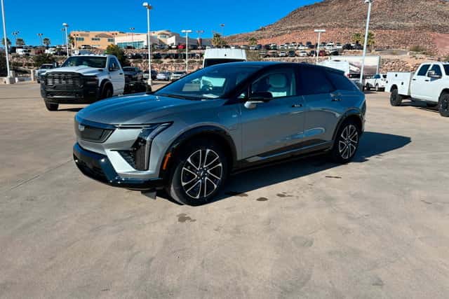 Gray 2026 Cadillac OPTIQ electric SUV parked outdoors, showcasing modern styling and EV capability in St. George, UT