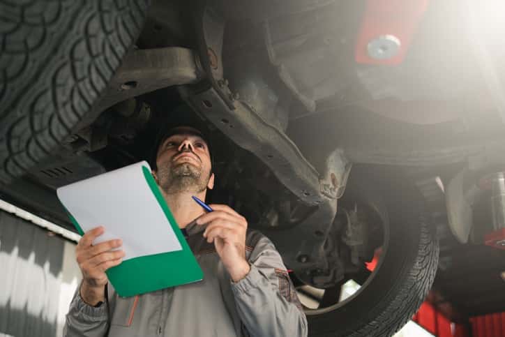 A technician is inspecting the vehicle seasonal checklist service in St. George, UT