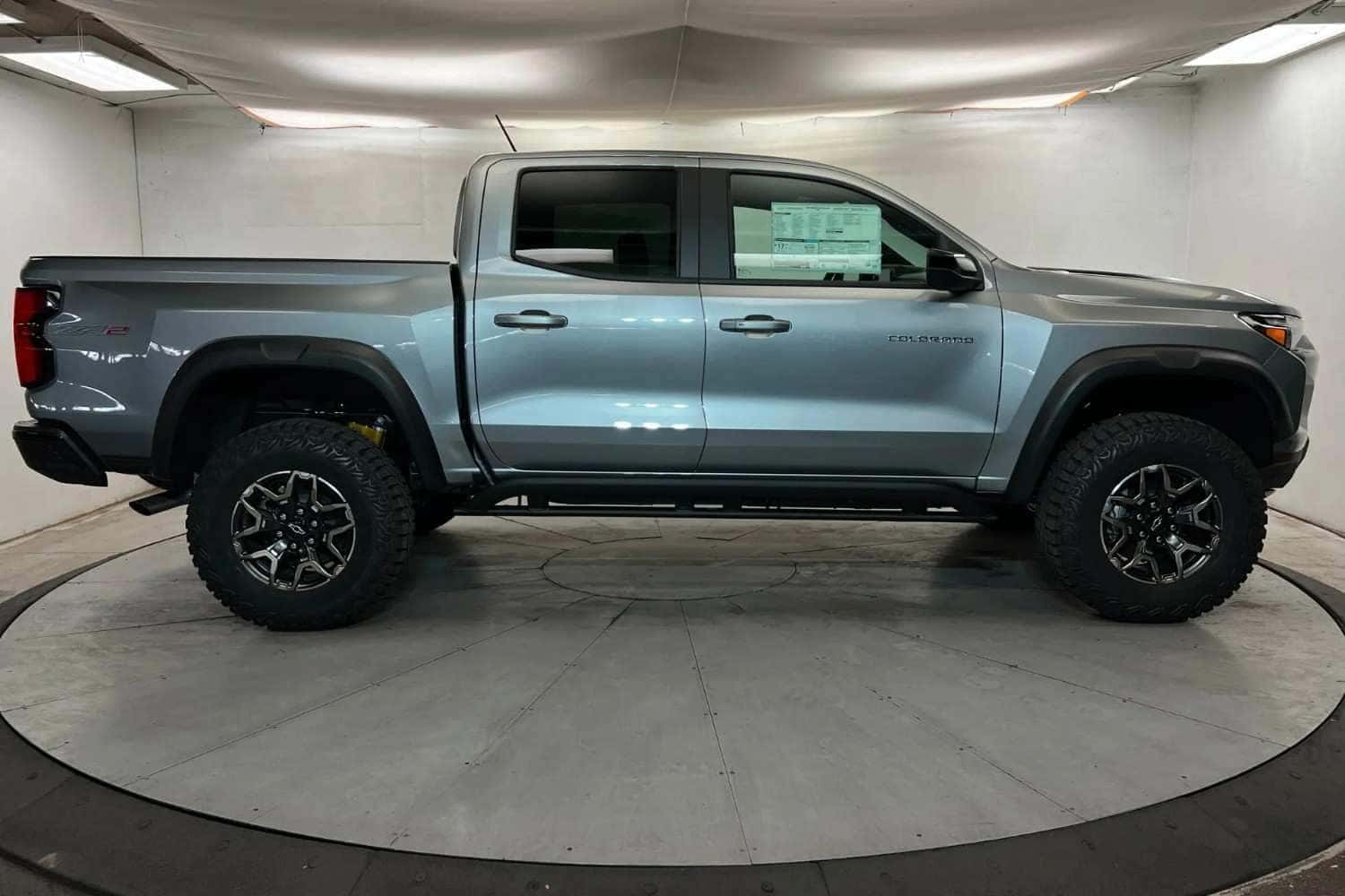 Side profile view of a 2026 Chevy Colorado pickup truck displayed indoors in St. George, UT