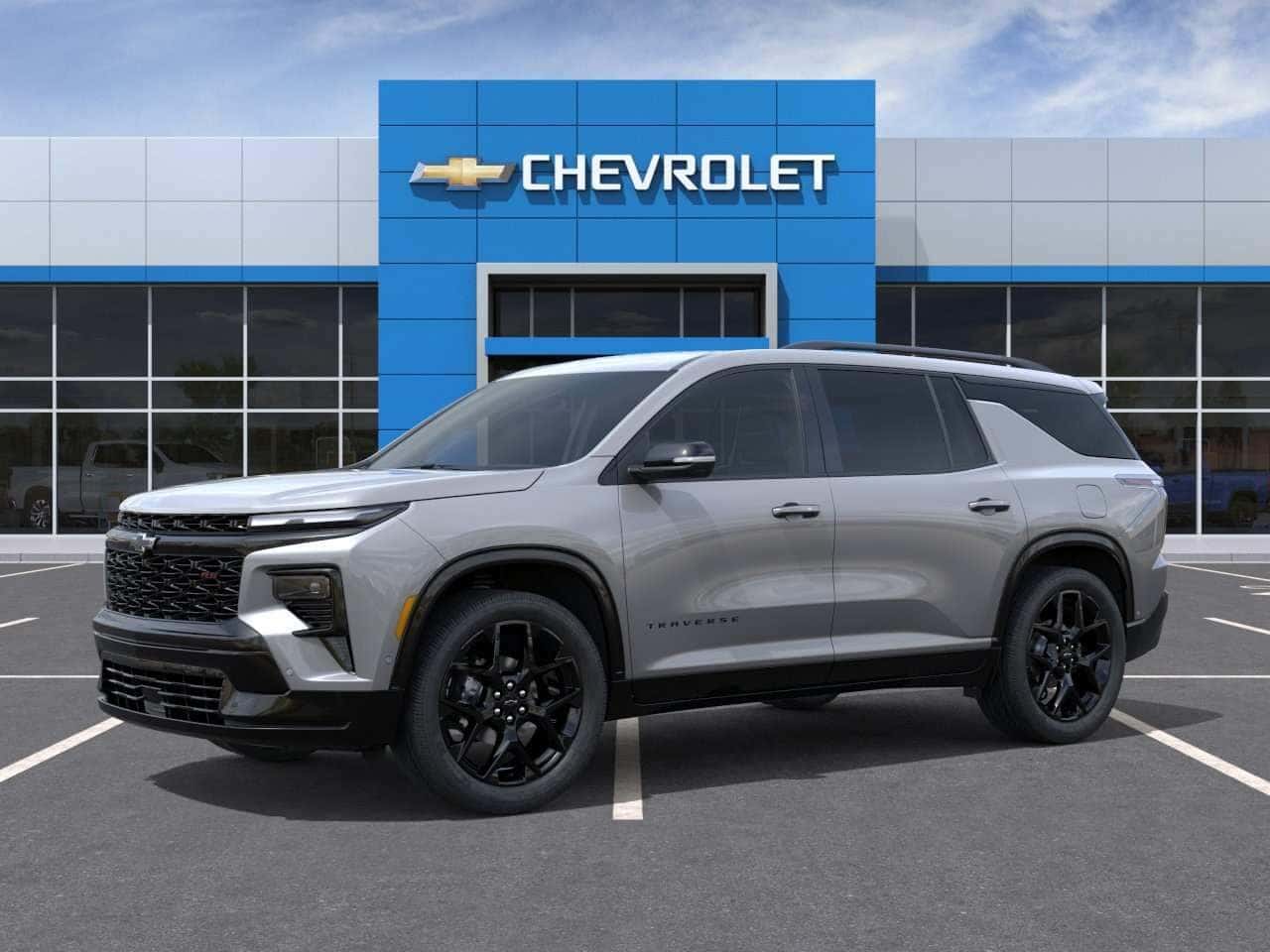 Front three-quarter view of a 2027 Chevrolet Traverse SUV parked outside a Chevrolet dealership in St. George, UT