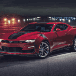 A 2024 Camaro in the middle of a runway in the night