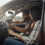 A couple sitting in an suv with the door open